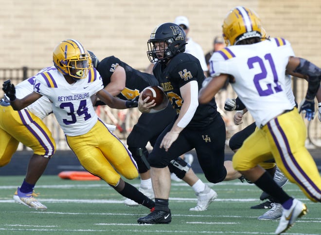 Upper Arlington's Carson Gresock tries to get by Reynoldsburg's Tehron Spencer (34) and Alex Crump-Whitson during the host Golden Bears' 42-41 win in the season opener Aug. 20. The rematch is Nov. 5 in a Division I, Region 3 quarterfinal at UA.