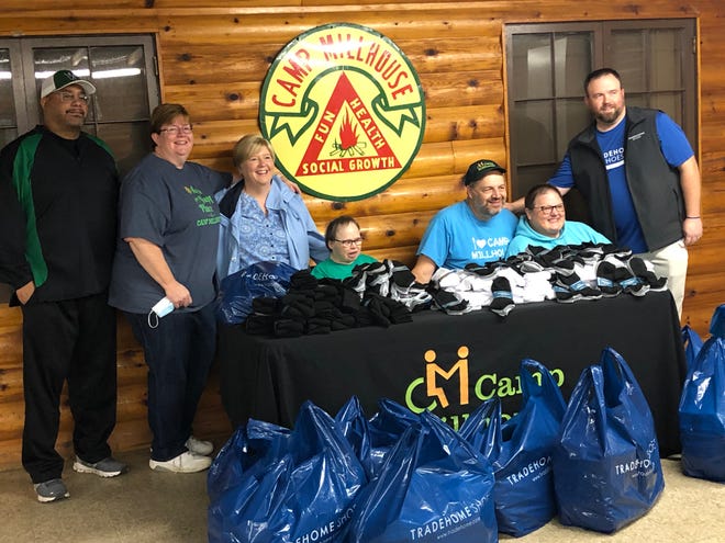 An anniversary promotion at Tradehome Shoes resulted in the donation of 500 pairs of socks to Camp Millhouse, which serves special needs children and adults.