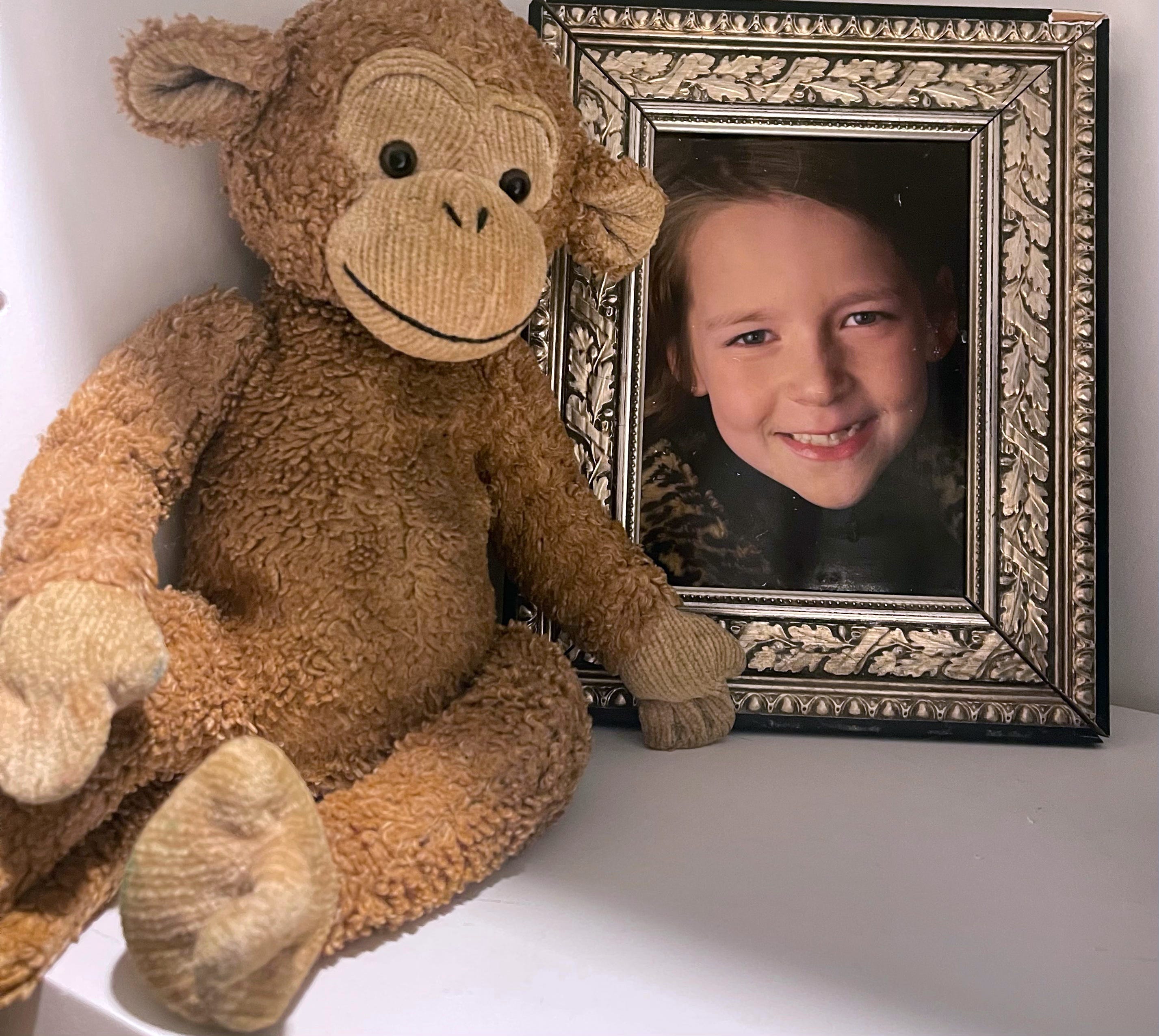 At Strategic psychiatric center, the environment fed Elizabeth Dickey's anxiety. She would punch walls when she had panic attacks and have to be sent to the padded room. The monkey next to her photo is her childhood stuffed animal since birth.