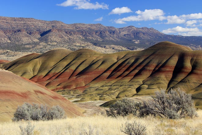 A view of the Painted Hills in the foreground with a view of Sutton Mountain rising behind it. A new 66,000 acre national monument proposal would create one larger recreation area from the two landmarks in Eastern Oregon.