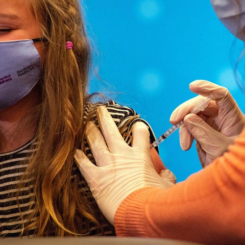 An 8-year-old child receives the Pfizer-BioNTech C