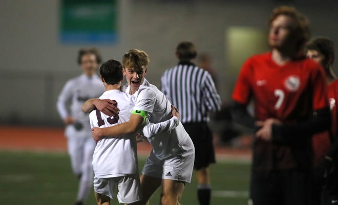 Ambridge's Chris Woten (19) celebrates his goal with Will Gruca (7) during the first half of the WPIAL 2A Consolation game against Charleroi Wednesday night at Peters Township High School.