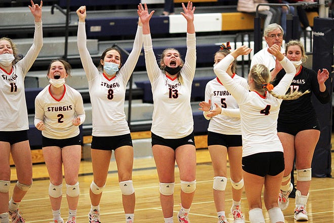 Sturgis players celebrate after going through the congratulations line with Coldwater after the Lady Trojans won in four sets on Wednesday.