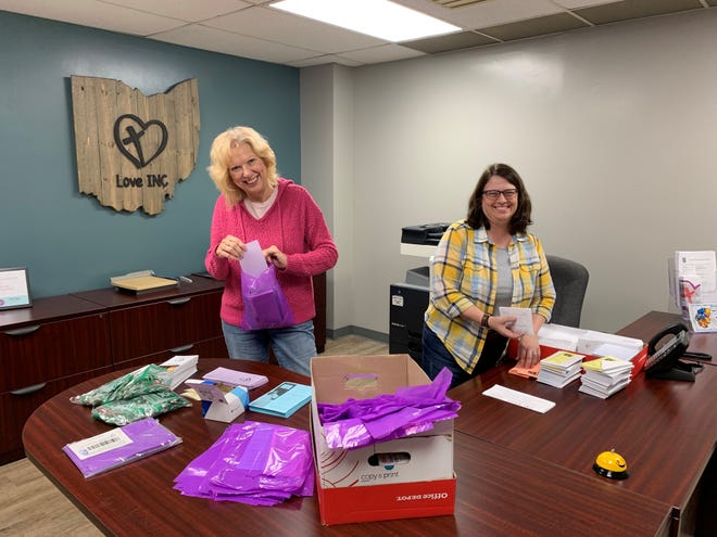 Jenni Hypes and Theresa Willis of Love INC prepare materials for the Nov. 6 Cost of Poverty Experience held at Cornerstone Alliance Church.