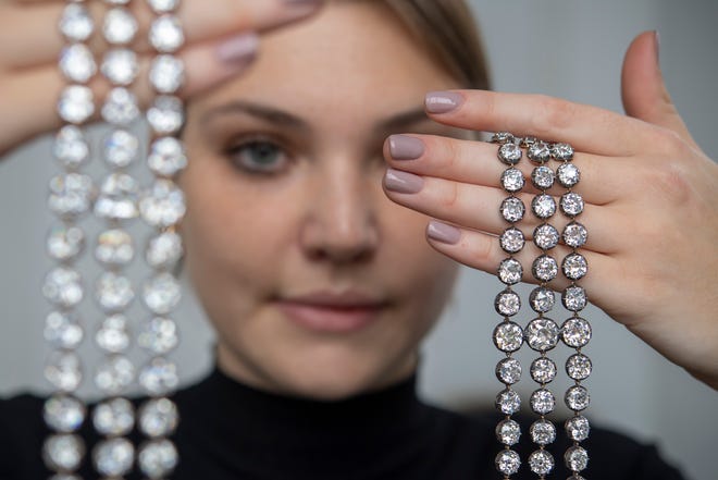 A Christie's employee displays a pair of diamond bracelets, with approximately 140 to 150 carats and owned by Queen Marie-Antoinette of France, in silver and yellow gold, circa 1776, during a preview at the Christie's, in Geneva, Switzerland, on Wednesday, Nov. 3, 2021. It is estimated to sell for up to $4.38 million. The auction will take place in Geneva on Nov. 9.