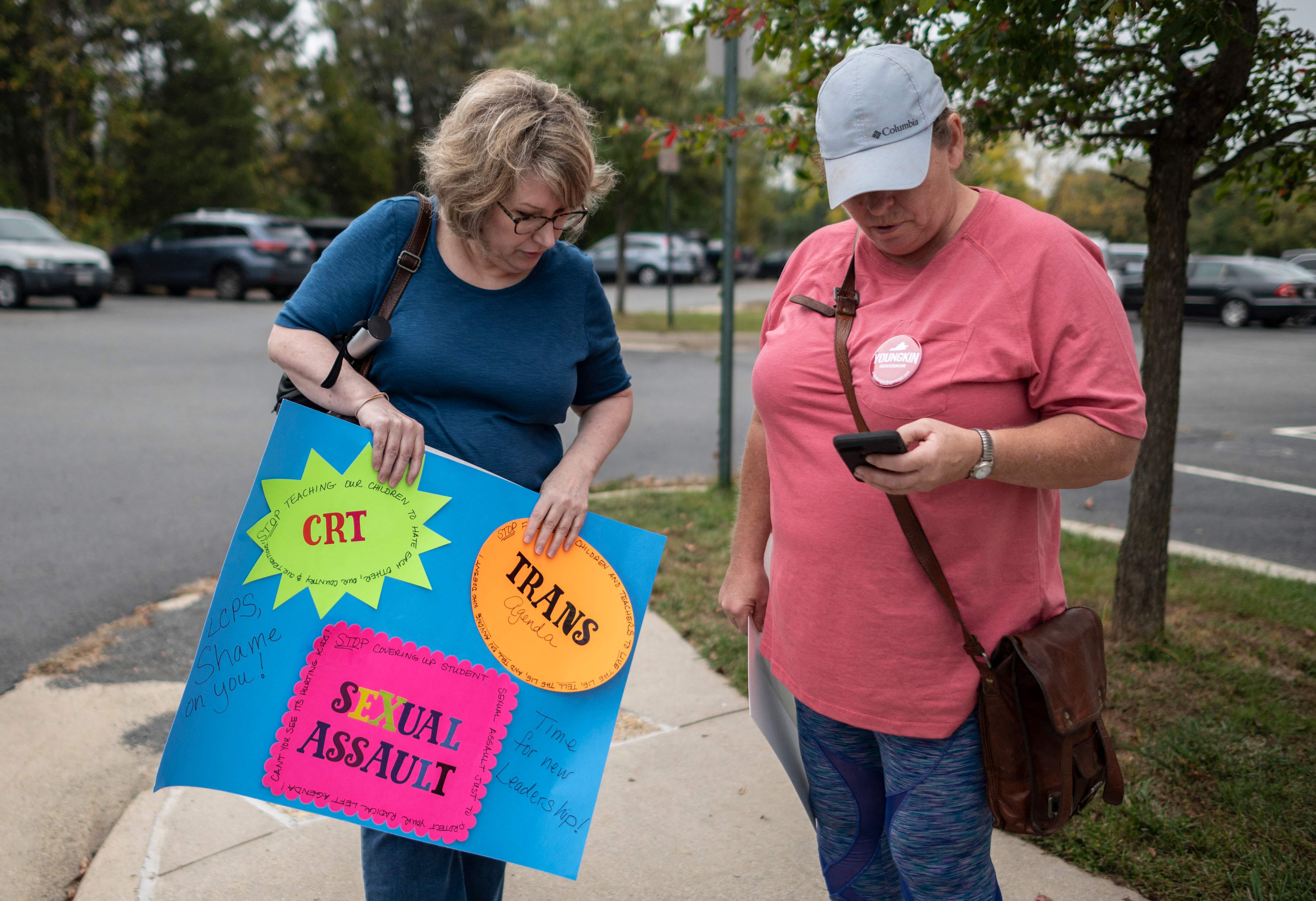 Protesters and activists stand outside a Loudoun County school board meeting in Ashburn, Virginia, last year. Board meetings had become tense, with parents clashing with board members over transgender issues, the teaching of critical race theory and COVID-19 mandates.