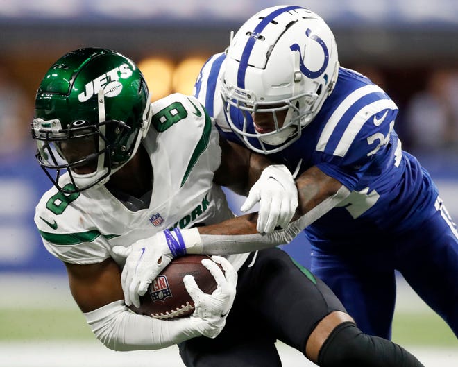 Jets wide receiver Elijah Moore hangs on as Colts cornerback Isaiah Rodgers tries to make a tackle Thursday in Indianapolis. Moore is trending in the right direction as a potential fantasy football asset.