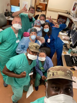 It was a common occurrence for James Fountain, executive director of the emergency department at Jackson-Madison County General Hospital, to get a group selfie like this sent to him to show how hospital staff and National Guard members were ready to work together at the beginning of a shift.