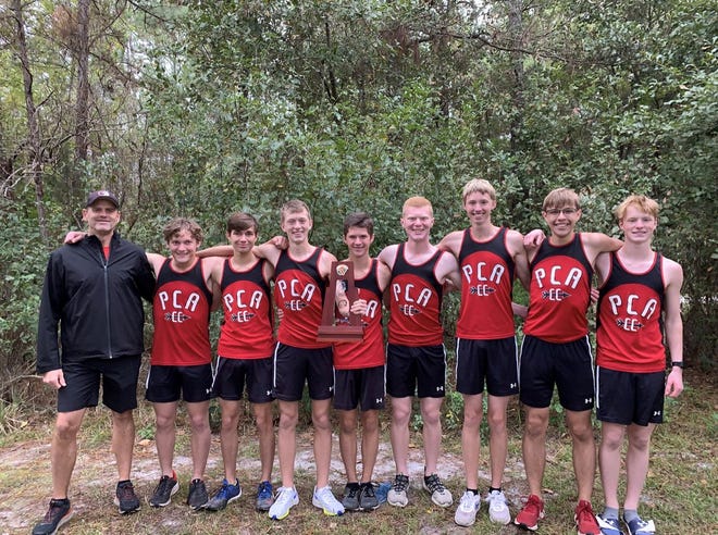 The Pensacola Christian Academy boys team celebrates its first cross country regional championship in program history after winning the Region 1-1A meet on Friday, Nov. 5, 2021 from the New World Sports Complex in Jacksonville.