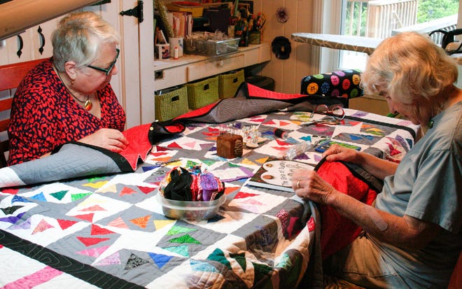 Carol Hyden and Stephanie Rubanowice work on the United Church of Tallahassee Quilt, which will be raffled off at the Artisan Market on Nov. 6, 2021.