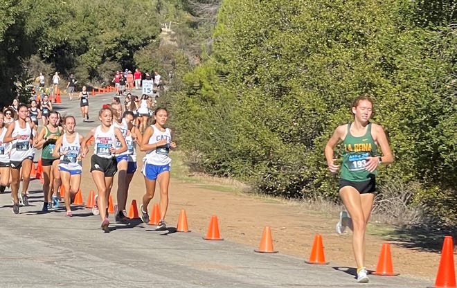 La Reina's Kaitlyn Ray leads the pack during the girls varsity race in the Tri-County Athletic Association cross country finals at Lake Casitas on Thursday afternoon. Ray finished first in 19:54.74.