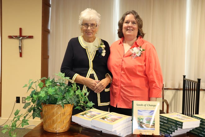 Sister Mary Louise Putrow, left, the primary author of "Seeds of Change: A History of the Adrian Dominican Sisters, 1962-1986," and Associate Arlene Bachanov, who served as the editorial assistant, are pictured Oct. 7 with copies of the fourth volume of the history of the Adrian Dominican Sisters congregation.