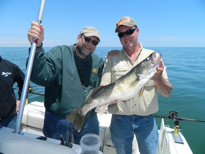 Bob Hanko, right, of Cranberry Creek Marina with a Lake Erie walleye. Jack Kiser is on the left.