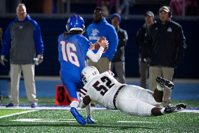 Henderson's Saadiq Clement (52) sacks Apollo's Christian Combs (16) during their 6A Round 1 playoff game at Eagle Stadium in Owensboro, Ky., Friday night, Nov. 5, 2021.
