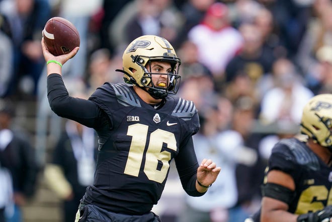 Purdue quarterback Aidan O'Connell (16) throws a pass against Wisconsin during the first half of an NCAA college football game in West Lafayette, Ind., Saturday, Oct. 23, 2021. (AP Photo/Michael Conroy)