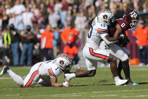 November 6, 2021; College Station, Texas, USA; Texas A & M Aggie's wide receiver Inia Smith (0) tackles Auburn Tigers safety Ladalia Stenison (13) in Kylefield in the first quarter. it was done.