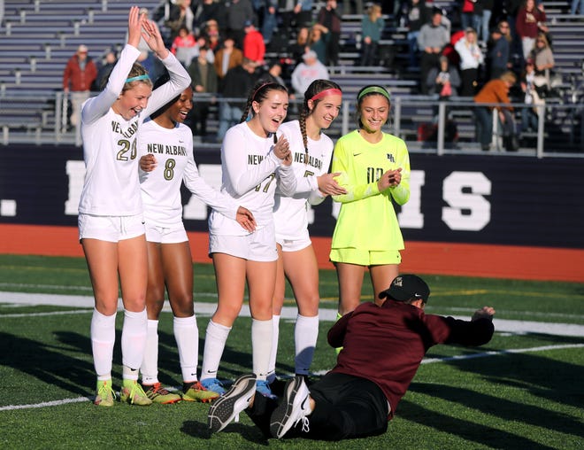 New Albany's Addison Scharver (left), Madisyn Rimpsey, Maci Sammons, Bella Ori and Emma Aniano cheer on coach Jared Dombrowski as he performs a worm dance after a 2-0 win over Olentangy Liberty in a Division I regional final Nov. 6 at DeSales.