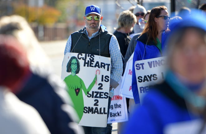 Ken LeBlanc of Clinton walks alongside his wife Carla on the picket line. St. Vincent's strike continues into its eighth month Nov. 7.