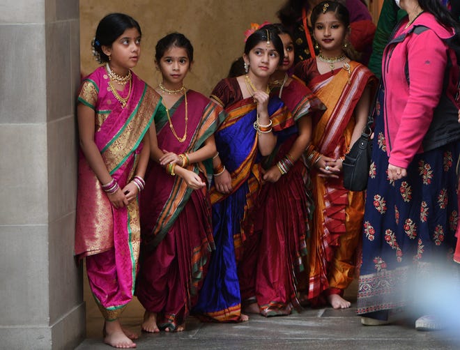 A small group of dancers watch the first group of singers at the start of the program in the Renaissance Court. India Society of Worcester held their Diwali celebration at the Worcester Art Museum Sunday.