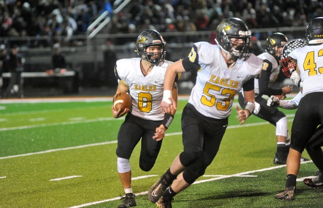 Colonel Crawford's Lincoln Mollenkopf carries the ball out wide as teammate Parker Ketterman leads him to block.
