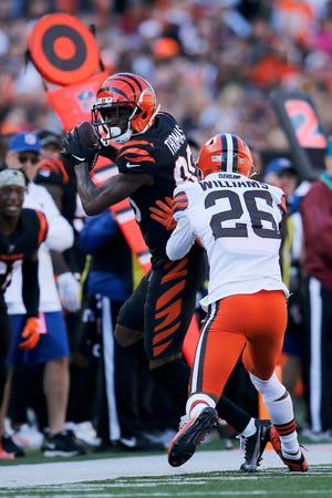 Cincinnati Bengals wide receiver Mike Thomas (80) catches a pass ahead of Cleveland Browns cornerback Greedy Williams (26) in the first quarter of the NFL Week 9 game between the Cincinnati Bengals and the Cleveland Browns at Paul Brown Stadium in Cincinnati on Sunday, Nov. 7, 2021. Cleveland led 24-10 at halftime. 