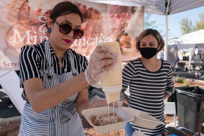 Eunice Herrera prepares her mini pancake plate at the South Central Mercado in Phoenix on November 6, 2021.