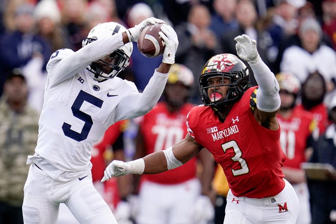 Penn State wide receiver Jahan Dotson (5) makes a catch against Maryland defensive back Nick Cross (3) during the first half of an NCAA college football game, Saturday, Nov. 6, 2021, in College Park, Md. (AP Photo/Julio Cortez)