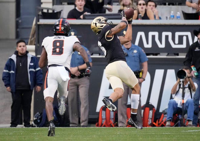 Colorado wide receiver Daniel Arias, right, pulls in a pass for a tocuhdown as Oregon State defensive back Elijah Jones covers in the first half of an NCAA college football game Saturday, Nov. 6, 2021, in Boulder, Colo.
