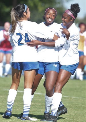 Teammates celebrate with Angelo State University's Grace Jordan, center, after she scored a goal against Midwestern State at the ASU Soccer Field on Saturday, November 6, 2021.