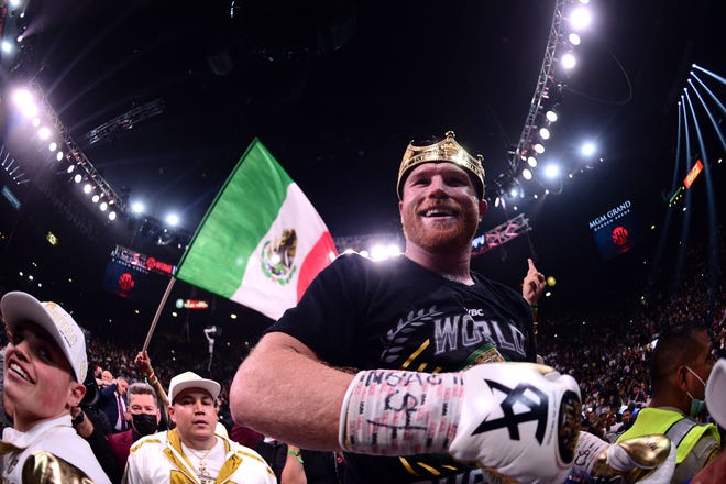 Canelo Alvarez celebrates after knocking out Caleb Plant during their super middleweight world championship boxing match at MGM Grand Garden Arena.