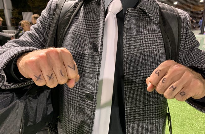 Quaker Valley boys soccer head coach J.J. Veshio displays his knuckles that read "XXIV" in honor of the late Ronny Hague Jr. and Geno, in honor of former Quaker Valley soccer head coach Gene Klein, whom is in the midst of a battle with cancer.
