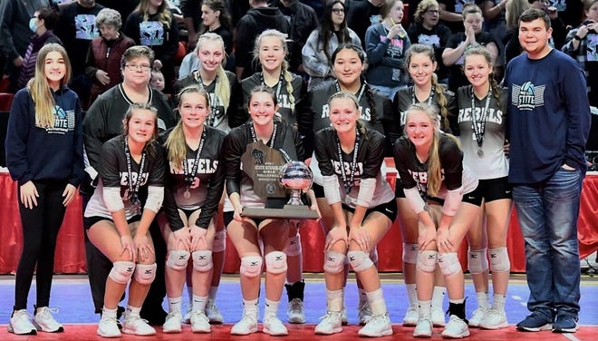 Members of the Wabeno/Laona volleyball team pose with their second place trophy after playing in the championship match of the Division 4 WIAA State Volleyball Tournament at the Resch Center in Ashwaubenon. From left, back row: manager Ave Cleereman, Coach Michelle Boor, Jaclyn St. Peter, Allison Albrecht, Lavara Gilpin, Vanessa Ponton, Grace Krawze, manager Daniel Harris; front row: Holly Gilligan, Paige Peterson, Braylee Chrisman, Elizabeth Krawze, and Malerie Krawze.