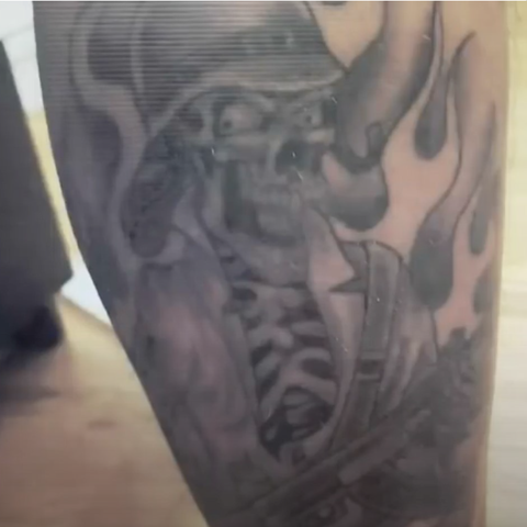 An officer's tattoo with the Executioner logo.