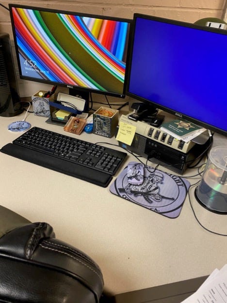 A desk with a mouse and mouse pad featuring the Executioners logo.