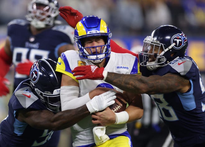 David Long #51 and Harold Landry #58 of the Tennessee Titans tackle Matthew Stafford #9 of the Los Angeles Rams during the first quarter at SoFi Stadium on November 07, 2021 in Inglewood, California.