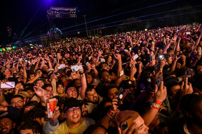 The crowd watches as Travis Scott performs at Astroworld Festival at NRG park on Friday, Nov. 5, 2021 in Houston. Several people died and numerous others were injured in what officials described as a surge of the crowd at the music festival while Scott was performing.