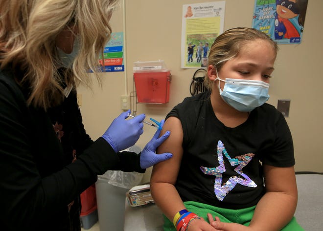 Allee Hill, 9, gets her pediatric dose of the Pfizer-BioNTech COVID-19 vaccine given by Karen Hammersmith, BSN, RN, at the Reno County Health Department Monday afternoon, Nov. 8, 2021.