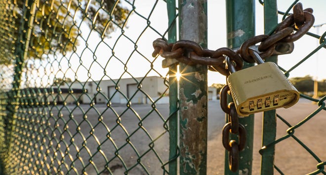 A chain and padlock secures the gate at the old Cone Distributing building on Tuesday. Green Ops Ocala has purchased the warehouse at 500 NW 27th Ave. for $3.2 million.