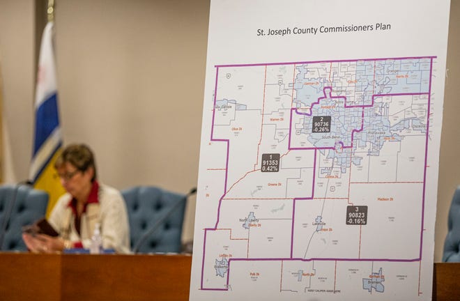 A proposed redistricting map is in the foreground as St. Joseph County commisisoners, including Deb Fleming, prepare for a public hearing on redistricting on Tuesday, Nov. 9, 2021.