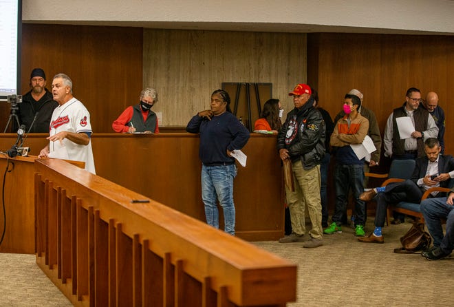 A line forms behind Dan Caruso, of New Carlisle, left, to speak against controversial new election maps proposed by St. Joseph County Commissioners President Andy Kostielney during a public hearing on Tuesday, Nov. 9, 2021, inside the County-City Building in South Bend.