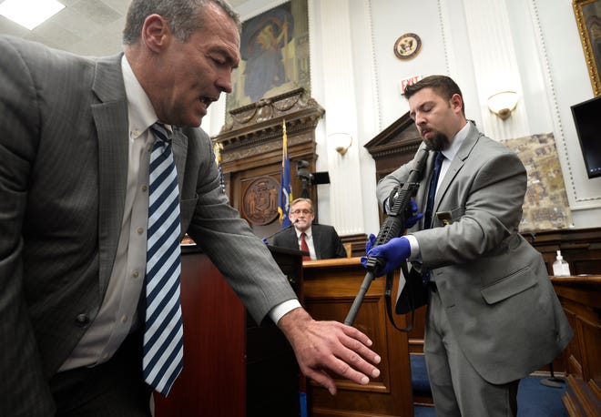 Mark Richards, left, lead attorney for Kyle Rittenhouse, gets help from Kenosha Police Department Det. Ben Antaramian demonstrating how Joseph Rosenbaum could have gotten shot in the hand by Rittenhouse as Douglas Kelley, center, a forensic pathologist with the Milwaukee County Medical Examiner's Office,  testifies at the Kenosha County Courthouse on Nov. 9, 2021, in Kenosha.
