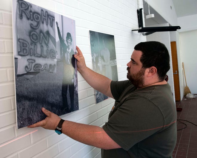 University of West Florida Historic Trust's Exhibition Technician Richard Rodriguez works on hanging an exhibit to honor women military veterans at the new Monument to Women Veterans on Tuesday, Nov. 9, 2021.