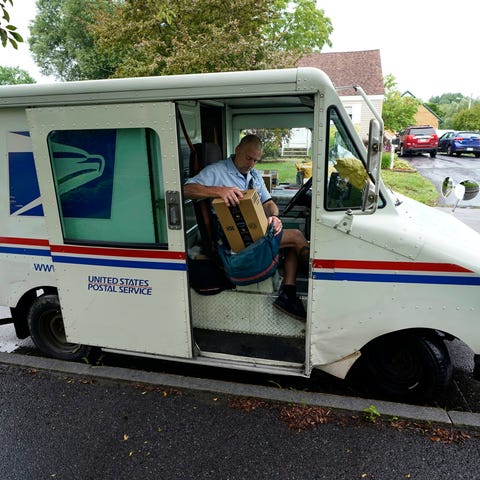 U.S. Postal Service carrier John Graham packs his 