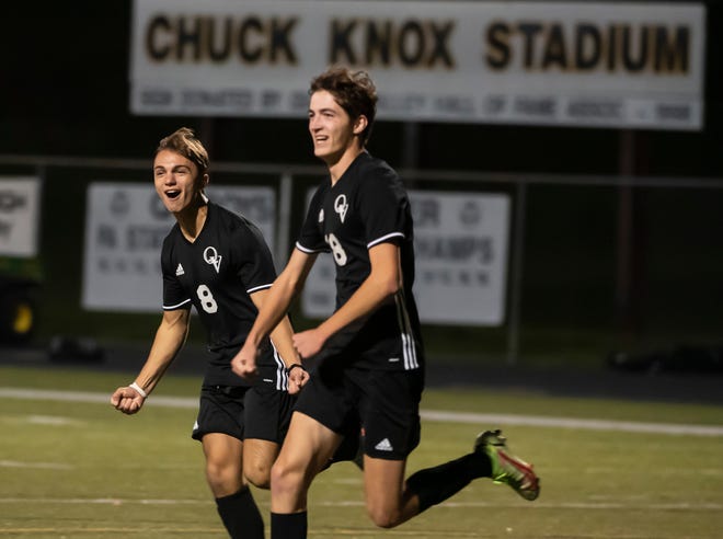 Quaker Valley's Luca Raymond (8) and Tim Smith (18) celebrate SmithÕs goal against Grove City during their PIAA playoff game at Chuck Knox Stadium. [Lucy Schaly/For BCT]
