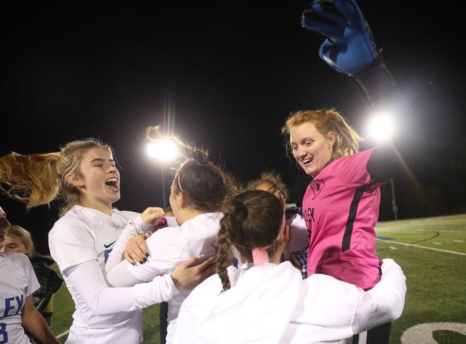 Lillian Hoyer (left) and goalie Katie Jude join their Bexley teammates to celebrate a 3-0 win over Steubenville in a Division II regional semifinal Nov. 2 at Zanesville West Muskingum. Jude, a senior, returned from injury during the postseason and helped lead the Lions to a state semifinal.