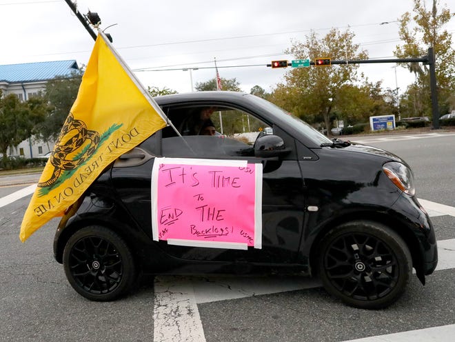 A caravan of veterans with signs and American Flags with the Concerned Veterans for America, drive through the parking lot of the Malcom Randall VA Medical Center to protest the Department of Veterans Affairs, in Gainesville on Nov. 10, 2021. This protest is part of more protests nationwide where the CVA is asking for more accountability and transparency from the VA.