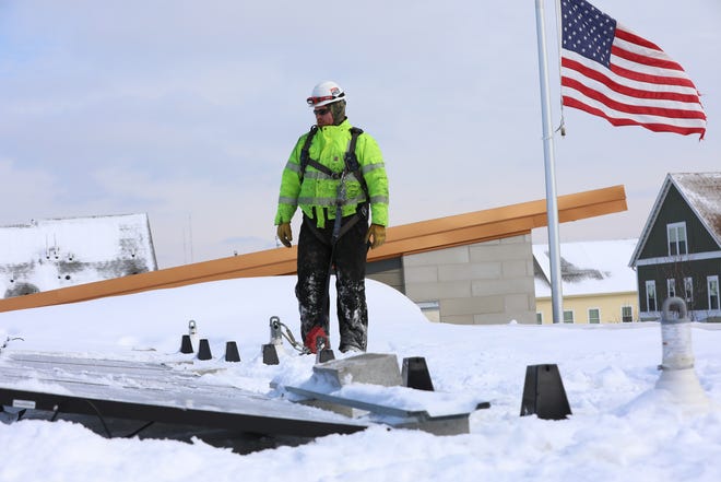 Cody Van Ginkel, an electrician with Arch Electric, surveys rooftop solar panels he helped install on the management and maintenance facility of Westlawn Gardens, a public housing project in Milwaukee, in February 2019. The installation was part of the city’s plan to draw 25% of its energy from renewable resources by 2025. The city wanted to partner with Eagle Point Solar to power several municipal buildings, but We Energies refused to connect the buildings to each other. Eagle Point sued We Energies and the state Public Service Commission — demanding that the agency take a stance on the legality of third-party solar arrangements. The Dane County Circuit Court dismissed the case.