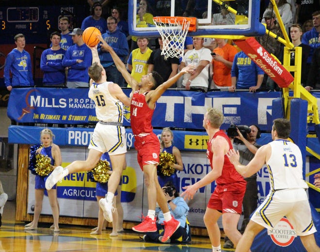 SDSU's Noah Freidel (15) takes the ball to the hoop against Bradley's Malevy Leons during the Jackrabbits' win over the Braves Tuesday night at Frost Arena