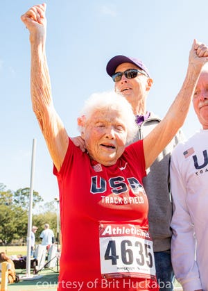 Julia "Hurricane" Hawkins raising her arms in triumph.