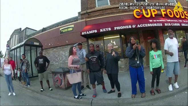 This May 25, 2020, file image from a police bodycam shows bystanders, some filming as former police officer Derek Chauvin pressed his knee on George Floyd's neck for several minutes in Minneapolis. Chauvin was sentenced to 21 years in federal prison after being convicted of murder.